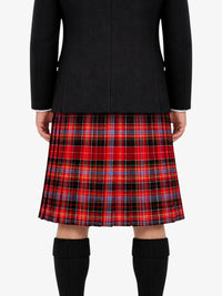 Person wearing a black jacket  and red plaid kilt on a white background