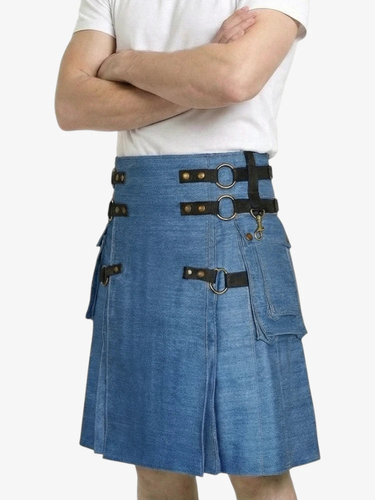 Blue denim kilt with black straps and buckles worn by a person on a white background