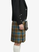 Person wearing a black jacket and plaid kilt on a white background