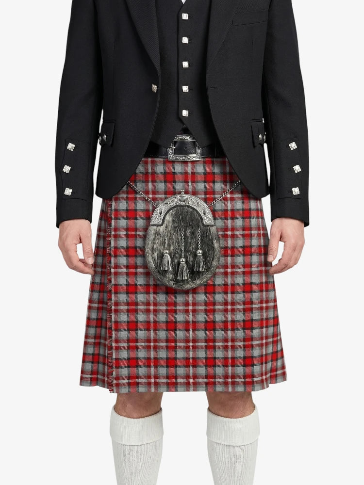 Person wearing a traditional Scottish kilt with a sporran on a white background