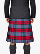 Person wearing a black jacket and red, blue, and purple plaid kilt on a white background