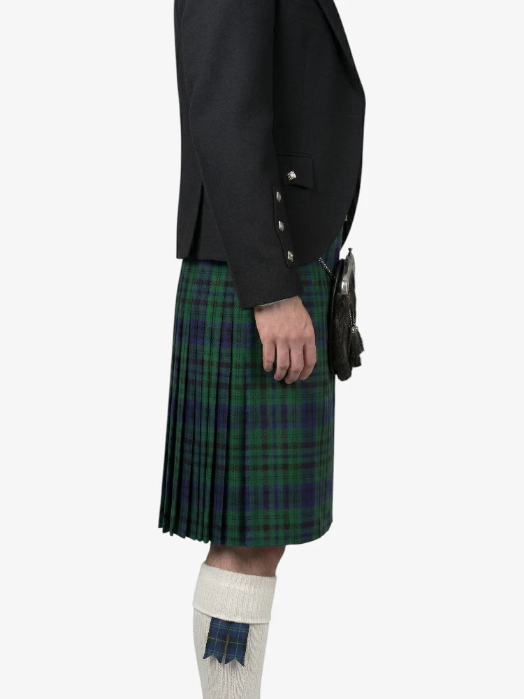 Person wearing a black jacket and green plaid kilt on a white background