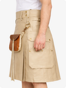 Beige cargo leather kilt with pockets and a brown leather bag on a white background