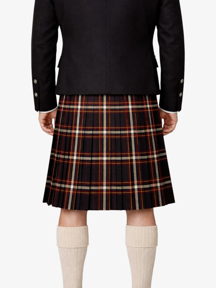 Person wearing a black jacket and plaid kilt  on a white background