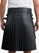 Black pleated kilt worn by a person on a white background