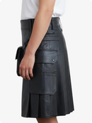 Black leather skirt worn by a person on a white background