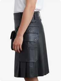 Black leather skirt worn by a person on a white background