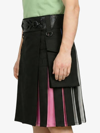Black and pink layered skirt worn by a person on a white background