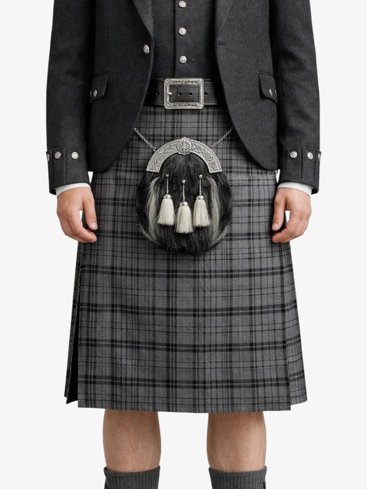 Person wearing a traditional Scottish kilt with a sporran on a white background