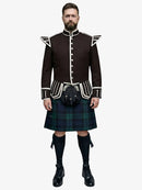 Man wearing a traditional Scottish black watch tartan kilt with a dark brown jacket on a white background