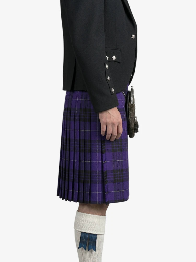 Person wearing a black jacket and purple plaid kilt on a white background