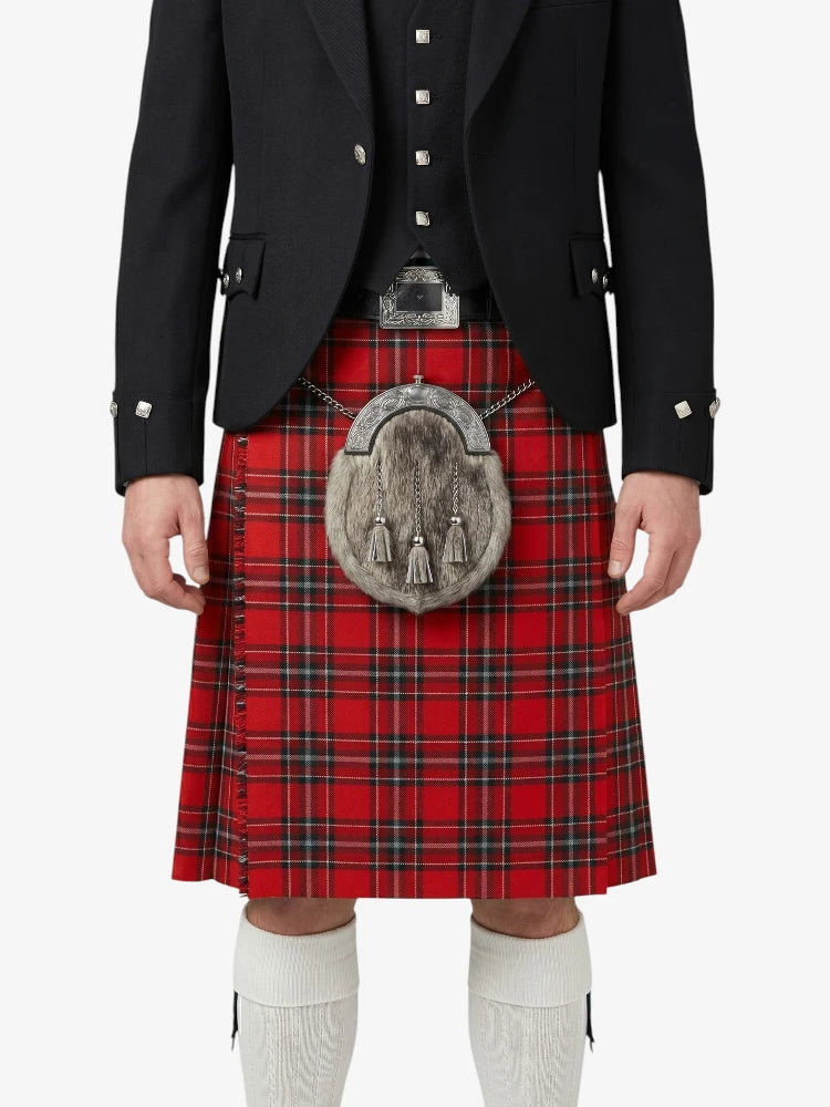 Person wearing a red tartan kilt with a black jacket on a white background