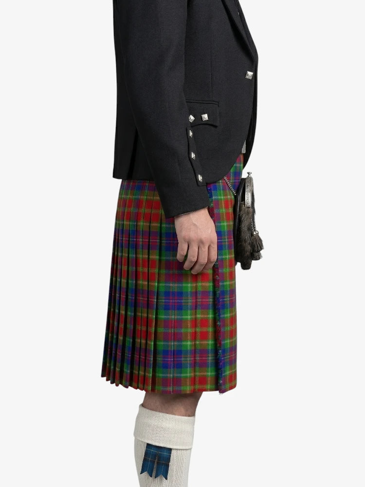 Person wearing a black jacket and a colorful plaid kilt on a white background