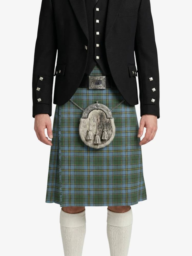 Person wearing a traditional Scottish kilt with a jacket on a white background