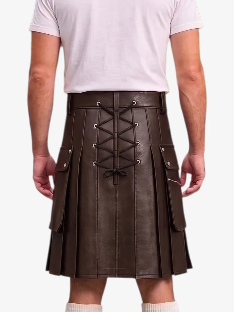 A man wearing a dark brown faux-leather kilt with a lace-up front, side pockets, and pleated detailing, paired with a light pink t-shirt and white socks.