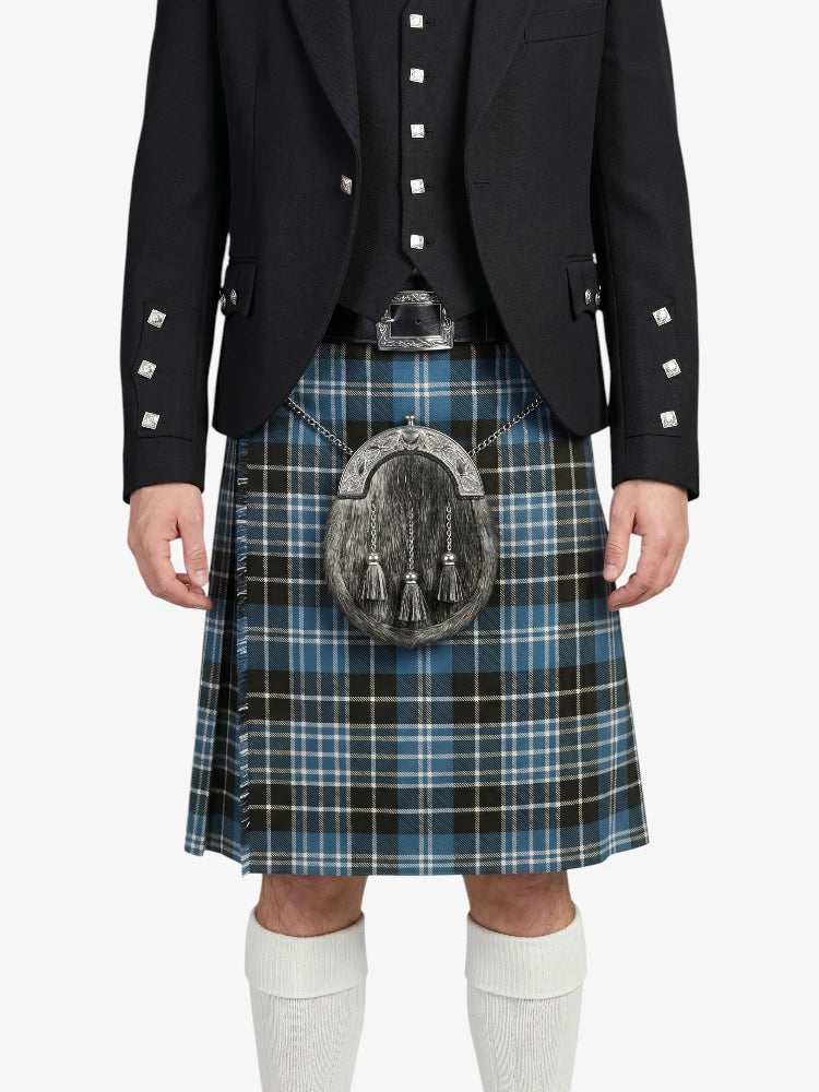 Person wearing a black jacket and blue plaid kilt on a white background