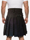 Person wearing a dark plaid kilt on a white background