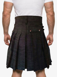 Person wearing a dark plaid kilt on a white background