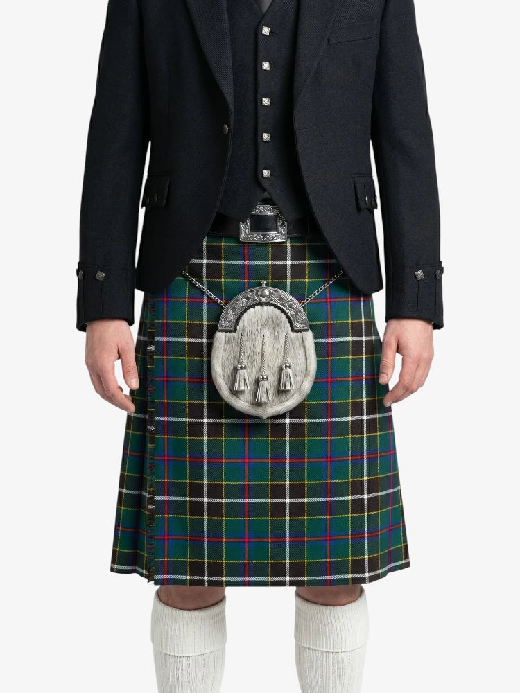 Person wearing a black suit with a green plaid kilt on a white background