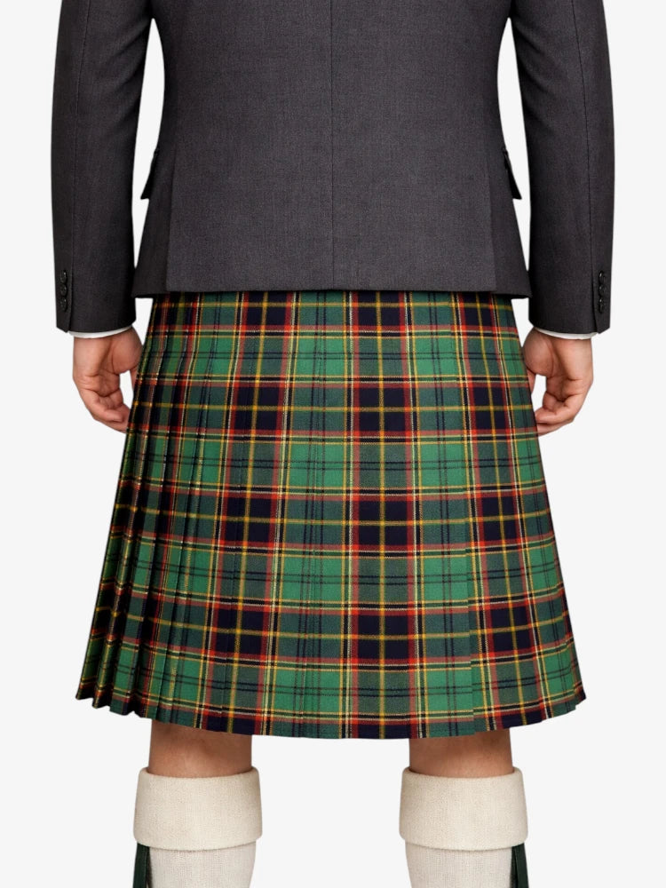 Person wearing a gray blazer and green plaid kilt on a white background