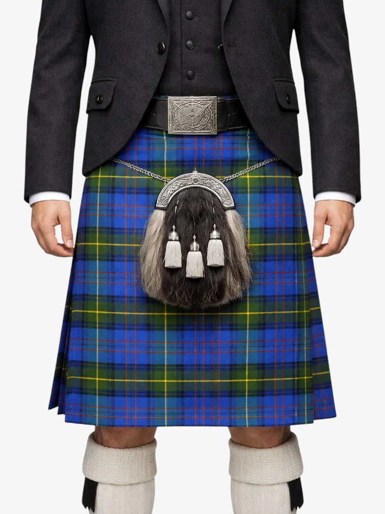Person wearing a traditional Scottish kilt with a tartan pattern on a white background