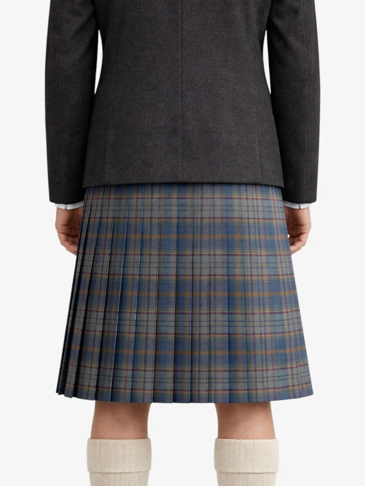 Person wearing a dark gray jacket and plaid kilt on a white background