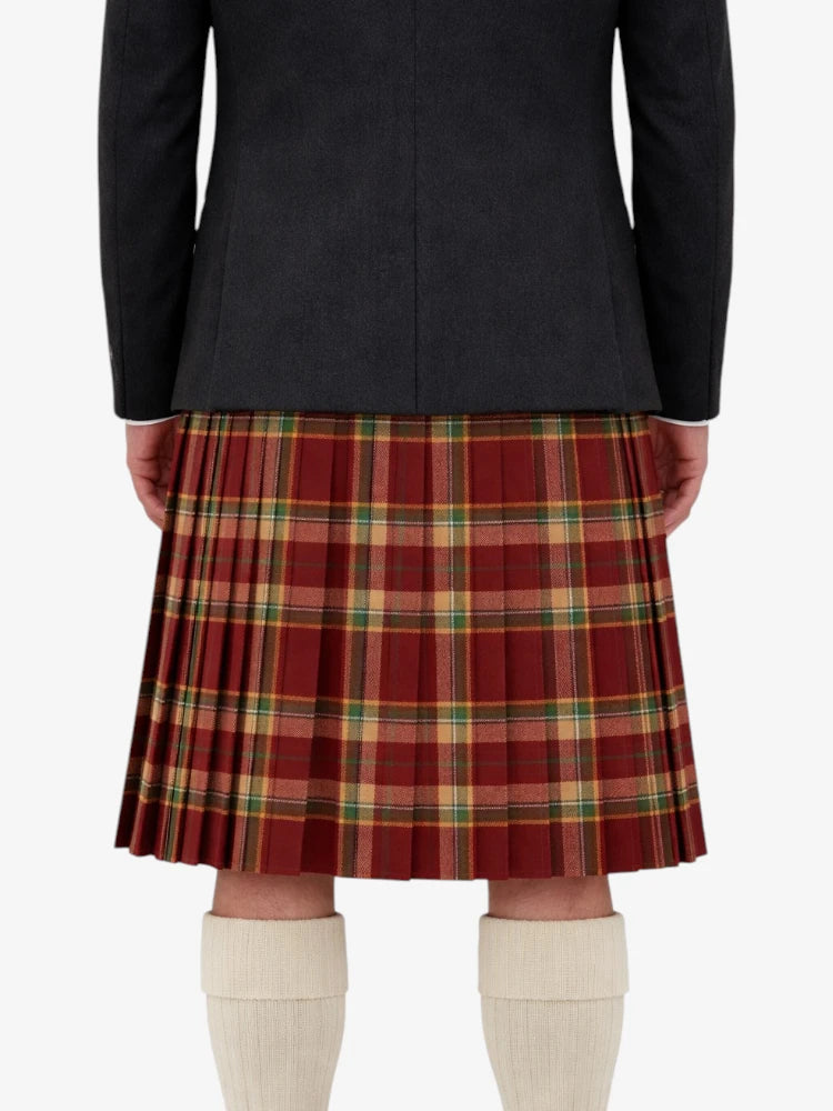 Person wearing a black jacket and red plaid kilt on a white background