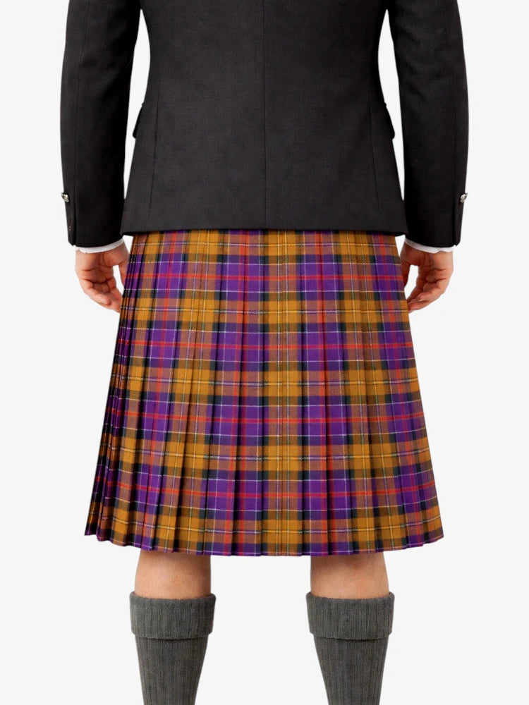 Person wearing a black jacket and a plaid kilt on a white background