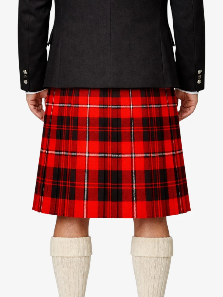 Red plaid kilt worn with a black jacket and white knee-high socks on a white background