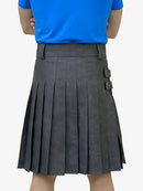 Person wearing a blue shirt and gray pleated skirt on a white background