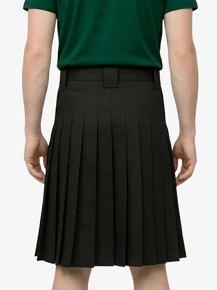 Person wearing a green shirt and black pleated skirt on a white background