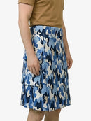Blue camouflage skirt worn by a person on a white background