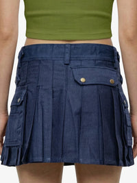 Navy pleated skirt with gold buttons worn by a person, on a plain background