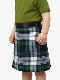 Child wearing a green shirt and plaid skirt on a white background