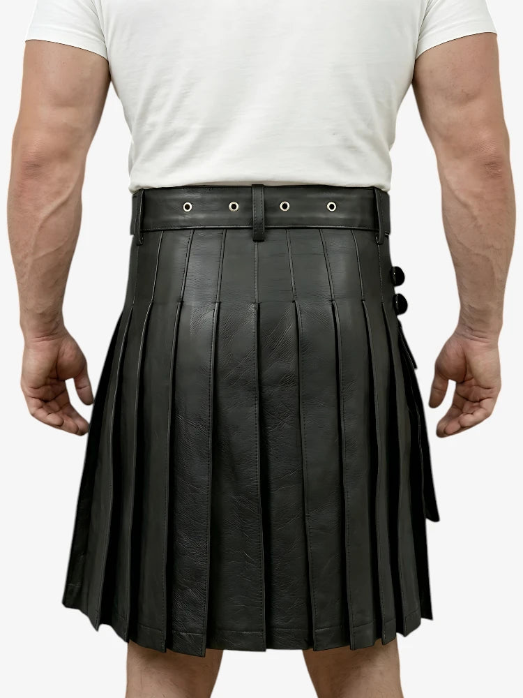 Person wearing a black pleated leather kilt on a white background