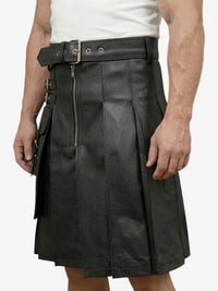 Person wearing a black leather kilt on a white background