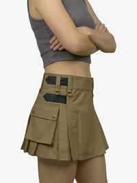 Person wearing a brown skirt with multiple pockets on a white background