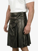 Person wearing a black leather kilt on a white background
