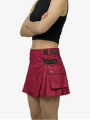 Person wearing a black crop top and red skirt with black accents on a white background