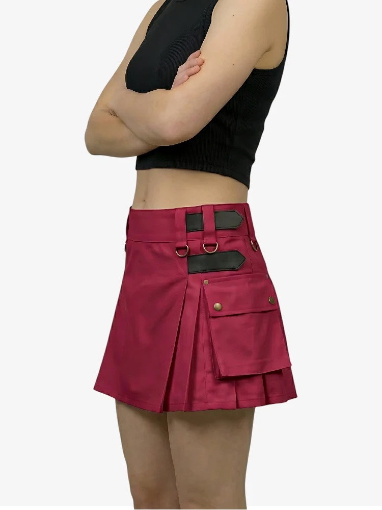 Person wearing a black crop top and red skirt with black accents on a white background