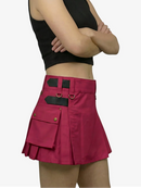 Person wearing a black crop top and red skirt with black accents on a white background