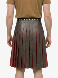 Person wearing a pleated skirt with brown and red color scheme on a white background