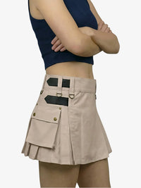 Person wearing a beige skirt with black accents on a white background