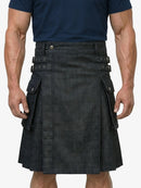 Person wearing a black kilt with visible buttons on a white background