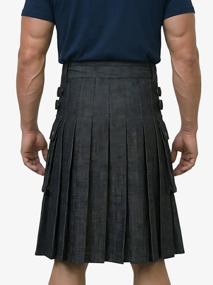 Person wearing a navy shirt and black pleated kilt on a white background
