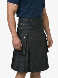 Person wearing a black kilt with multiple belt buckles on a white background