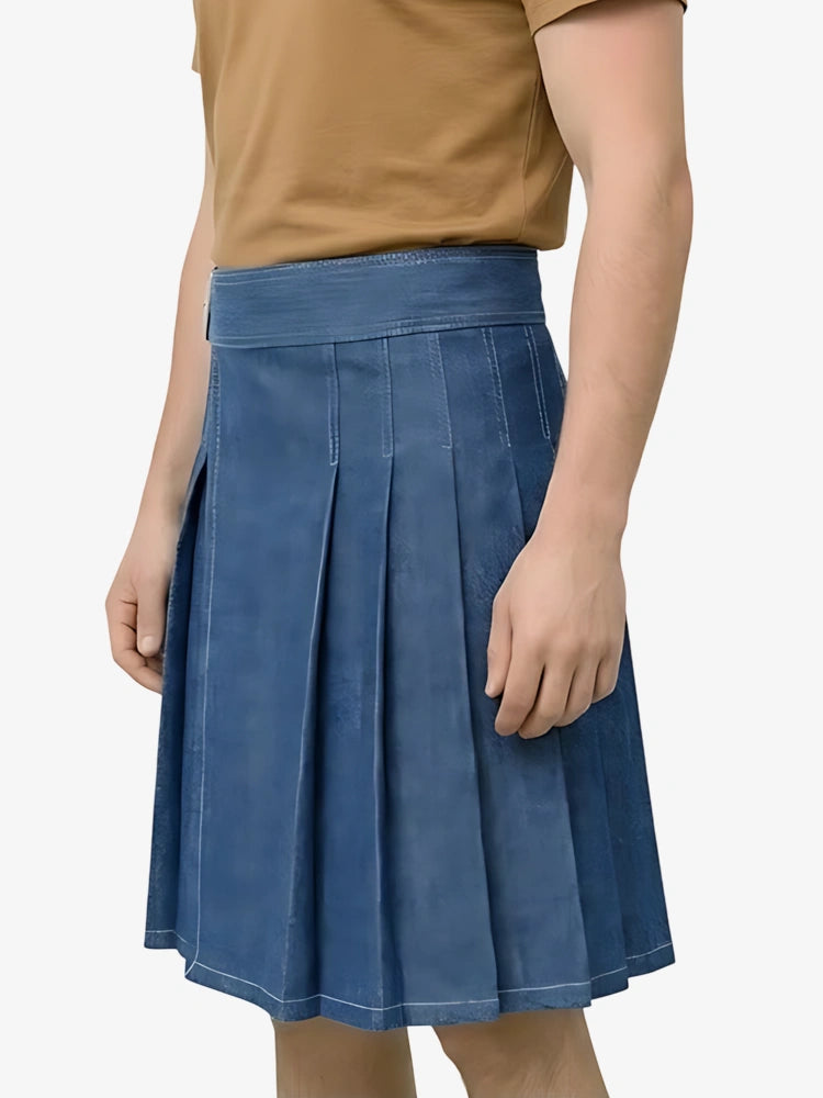 Person wearing a blue pleated skirt on a plain background