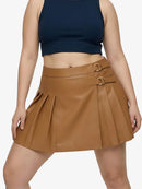 Person wearing a brown pleated skirt with gold buckles on a white background