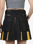 Black cargo skirt with yellow accents worn by a person on a white background