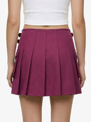 Purple pleated skirt worn by a person on a white background